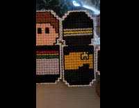 Woman shows cross stitch designs for fridge