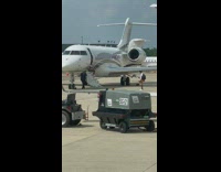 Guy sit on private plane stairs airport