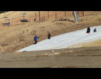 Woman poses at the snowy slope hill