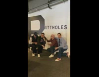 IITW - four guys pose in front of buttholes sign