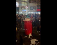 Guy walks at street wearing lighthouse costume