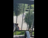 White shirt girl sits concrete planter balcony 