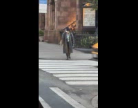 Man white face paint crosses the road