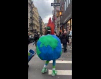 Woman Earth costume sings on the street