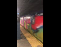 Subway car covered in colorful graffiti 