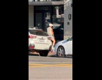 Man dances outside the Winslow building entrance