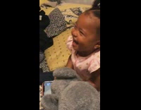 Baby laughs at toy beat up 