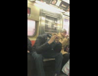 Guy does Rubik's cube with head down without looking on subway train