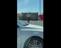 Guy red shirt employee swing stick car