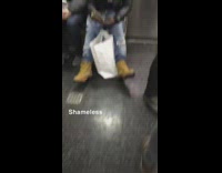 Guy rolls a joint to smoke weed on subway train
