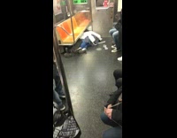 Couple falls asleep on the corner of the floor inside subway train