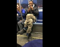 Man lights and smokes cigar on metro train