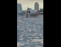 Guy slap butt girl piggyback beach chair