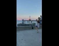 Woman crop top sit and face the beach at sunset