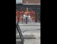 Three men employee tiktok dance in front of restaurant