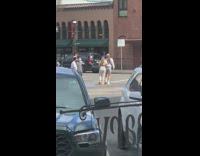 Two girls hat raise foot pose street