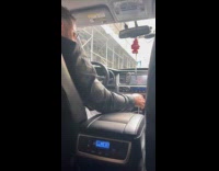 Man drives and turns car music up