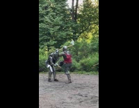 2 guys in armor have medieval battle 