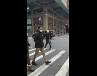 Guy holding ball stands frozen on crosswalk 