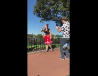 Girl red skirt Disneyland pretends to lick ice cream cone