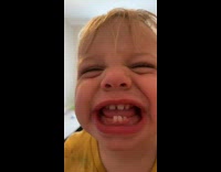 Baby boy cry then smile at camera