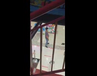 Guy walking down stairs watches person dancing 