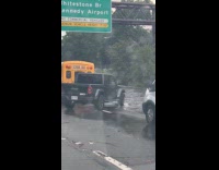 Jeep rams through deep flood at highway