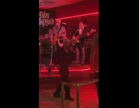 Elderly man shows off dance moves while band performs 