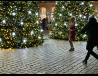 Woman in shiny red dress jump ropes at the park