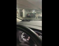 Woman white pants handbag strut parking lot