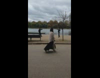 Woman in black leather jacket tiktok dance near the lake