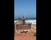 Lady gets blown off sign by wind 