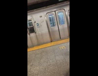 Two girls hang onto back of subway
