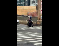 Man Loco Coco juggle pins on crosswalk
