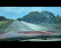 Big Truck with a small toy truck on its load at the highway