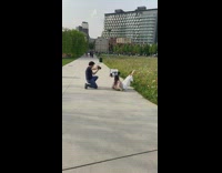 White pants girl sits sidewalk feet raised 