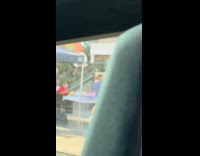 Woman blue dress yellow fur coat on sidewalk 