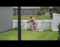 Man shirtless blue shorts mows the lawn