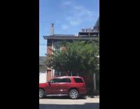 Woman lays on her roof top to suntan for the summer