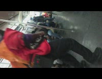 Guy wearing red jacket dances in subway 