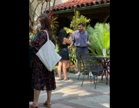 Man in floral polo top dance in front of the plants