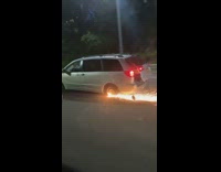 Silver minivan missing back tire rim sparks 