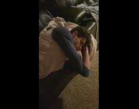 Grey white dog lays behind sleeping guy 