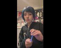 Woman puts a light stick on her nose piercing 
