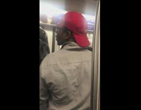 Red hat guy hand pole subway train 