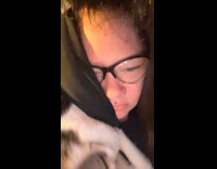 Cat lies down on top of woman