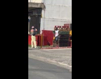 Man poses near wooden platforms on street