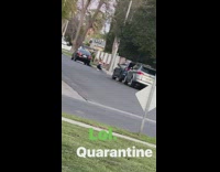 Black leggings girl squats next to curb 