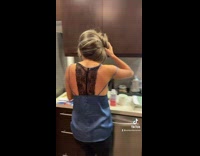 Girl walks around house toothbrush in mouth picks up bottle 