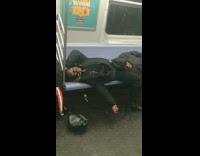 Two men lay down and fall asleep on each other in subway train